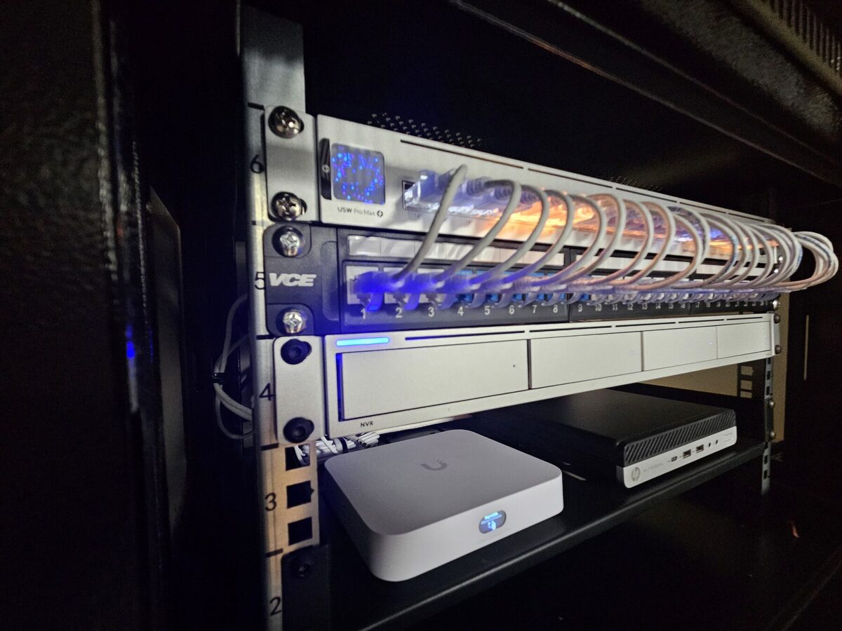 UniFi Protect equipment rack with UNVR Pro recorder, USW Pro Max 24 PoE switch and patch panel installed at an apartment building in London, Ontario.
