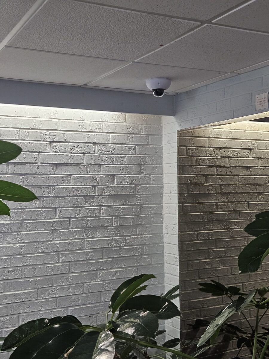 UniFi G6 Dome security camera mounted in the lobby common area of a London, Ontario apartment building.