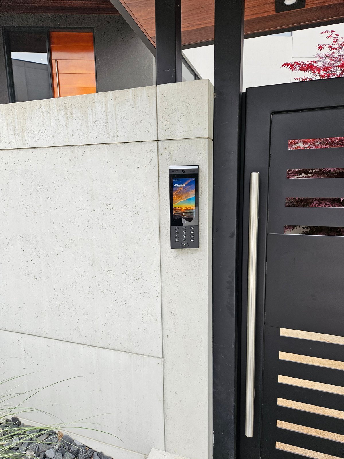 UniFi G3 Intercom mounted flush in a custom concrete and steel entry gate at a lakeside home in Sarnia, Ontario