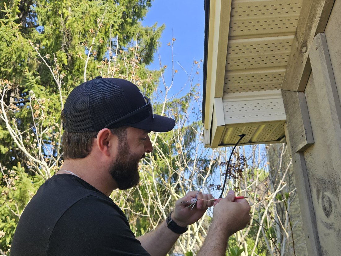 London Tech Solutions technician terminating Cat6 cable for an exterior camera install at a London Ontario home