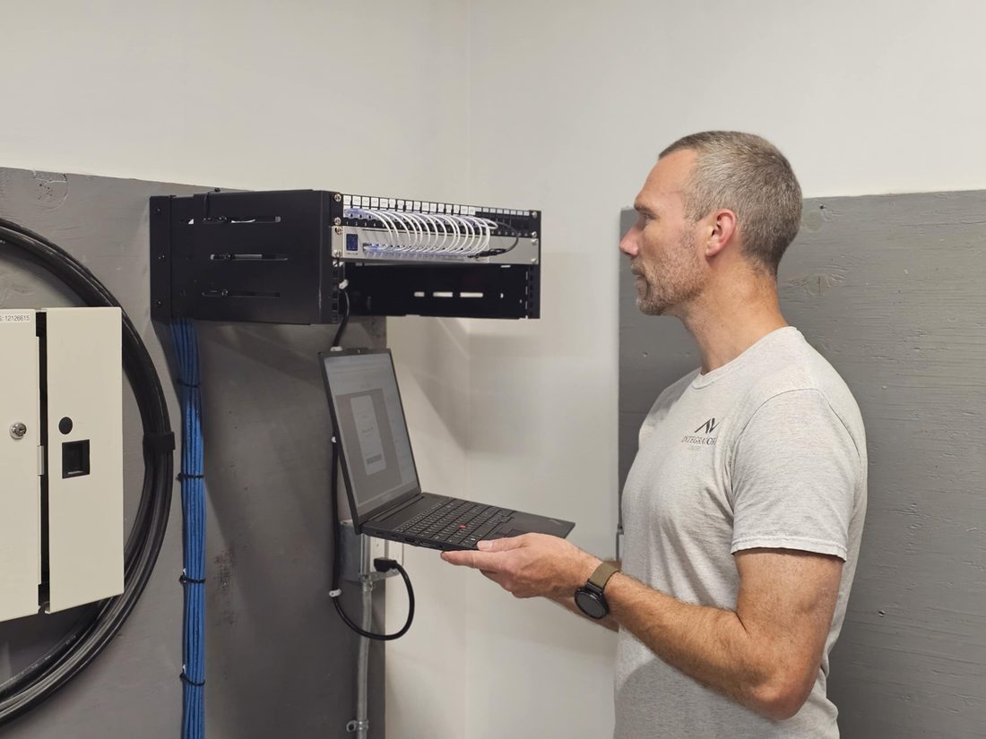 Kyle Greenwood, owner and lead technician at London Tech Solutions, configuring a network rack