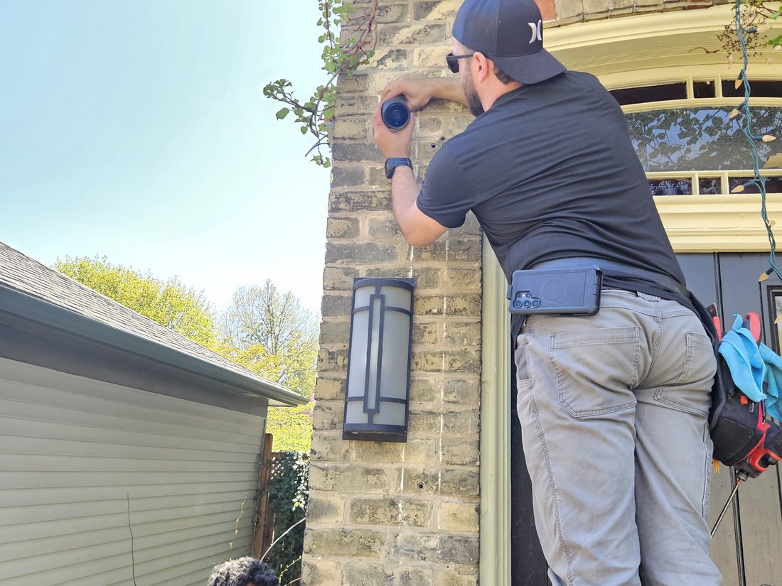 London Tech Solutions technicians installing a security camera on a London Ontario home